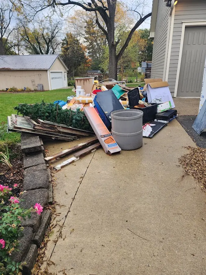 Dumpster being loaded with debris for 30 Yard Dumpster Rental in Howell